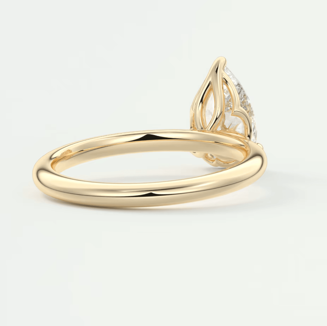 18k yellow gold engagement ring with a marquise-cut diamond.