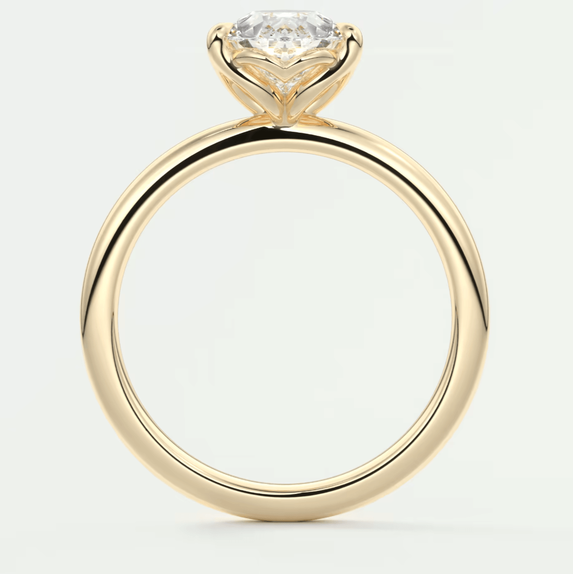 18k yellow gold solitaire diamond engagement ring with a cushion-cut center stone.