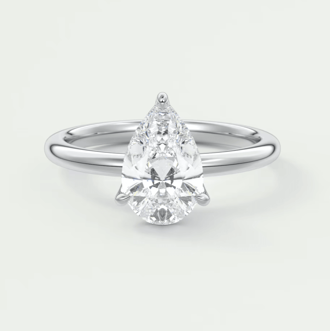 Pear-shaped diamond engagement ring with a white gold band and prong setting.