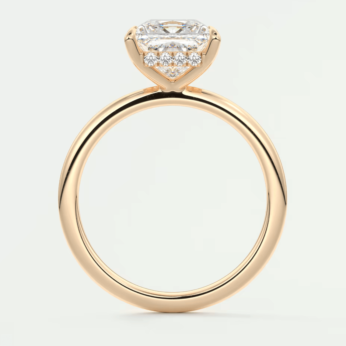 18k rose gold engagement ring with a princess cut diamond and small diamonds on the band.