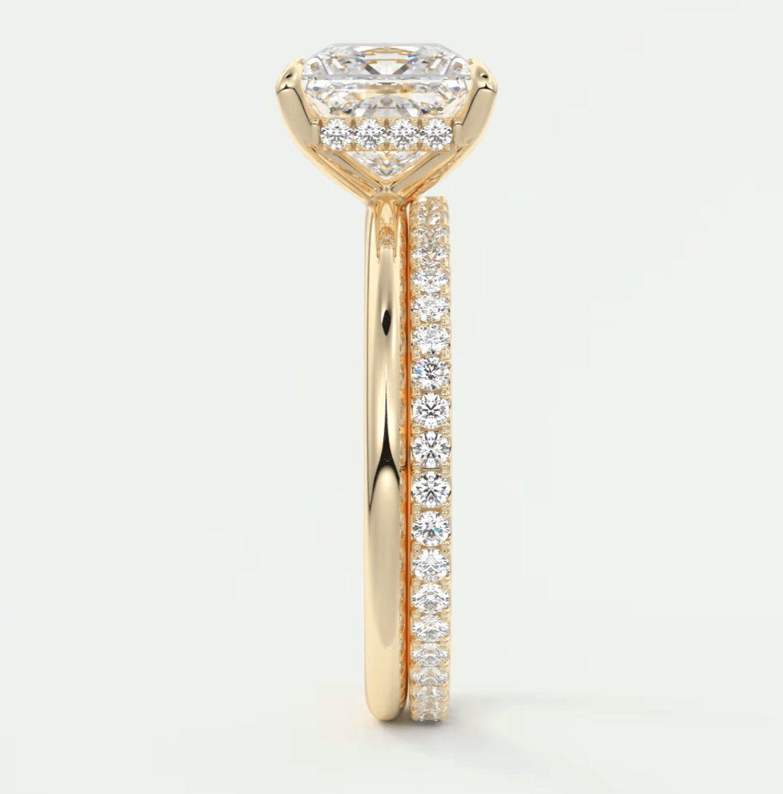 18k yellow gold engagement ring with a princess cut diamond and pave set diamonds on the band.