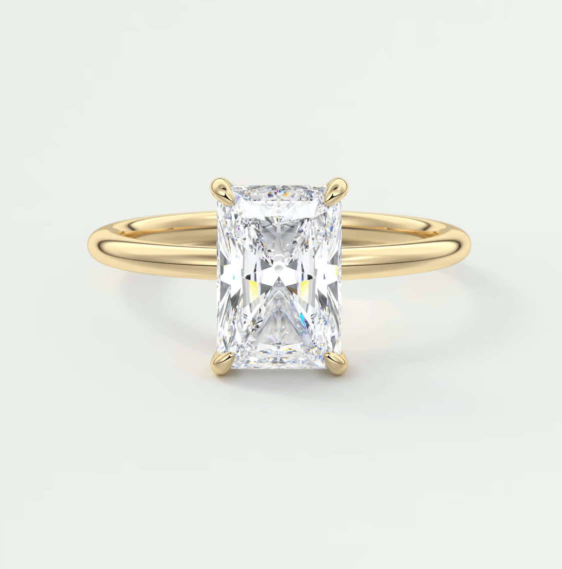 18k yellow gold engagement ring with a radiant cut diamond.