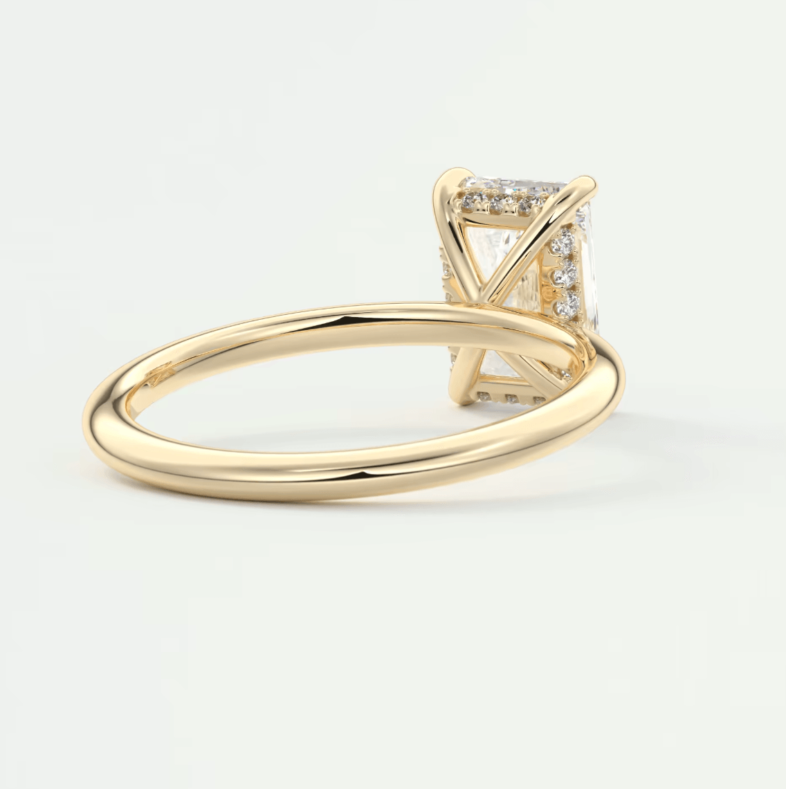 18k yellow gold princess cut diamond engagement ring with a halo of diamonds.