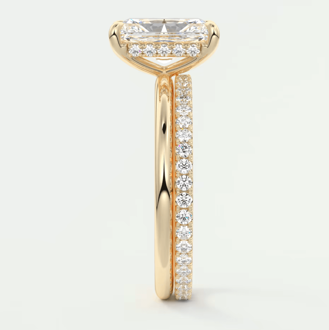 18k yellow gold engagement ring with a princess cut diamond and pave set diamonds on the band.