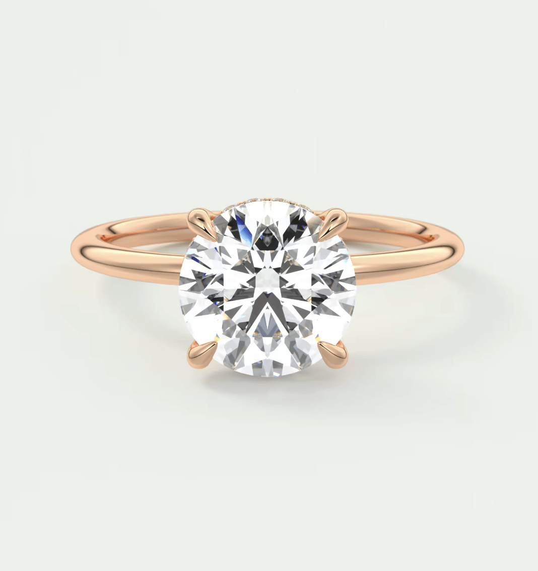 18k rose gold diamond engagement ring with a round brilliant cut gemstone.