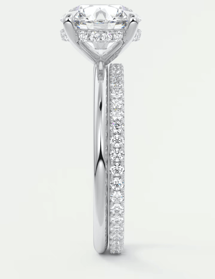 18-karat white gold diamond engagement ring with a round-cut center stone and pave-set diamonds on the band.