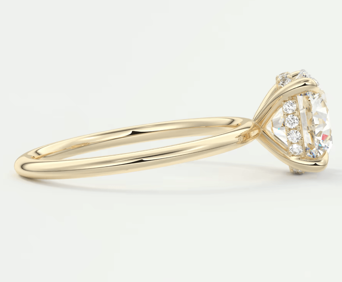 18k yellow gold engagement ring with a round diamond center and smaller diamonds on the band.