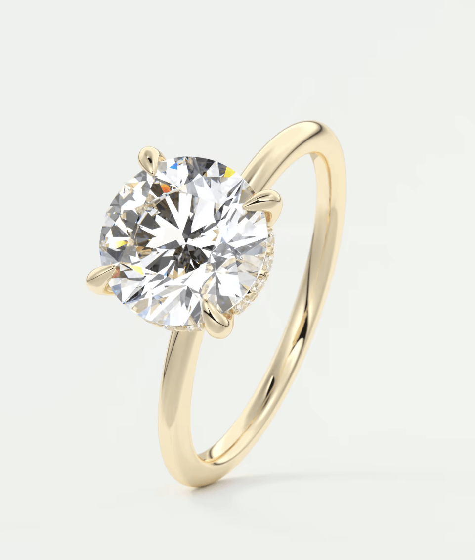 18-karat gold solitaire diamond engagement ring.