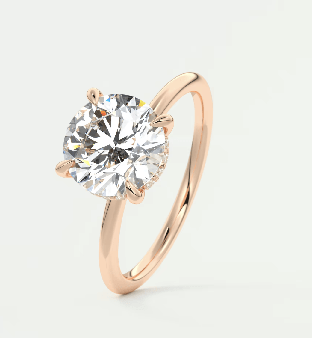 18-karat rose gold solitaire diamond engagement ring.