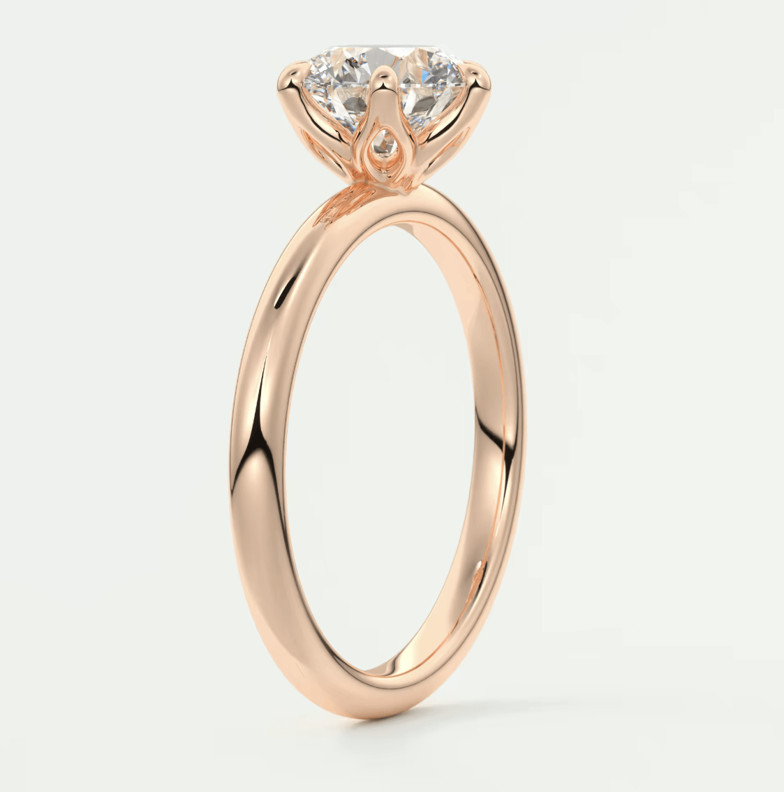 18k rose gold engagement ring with a round diamond.