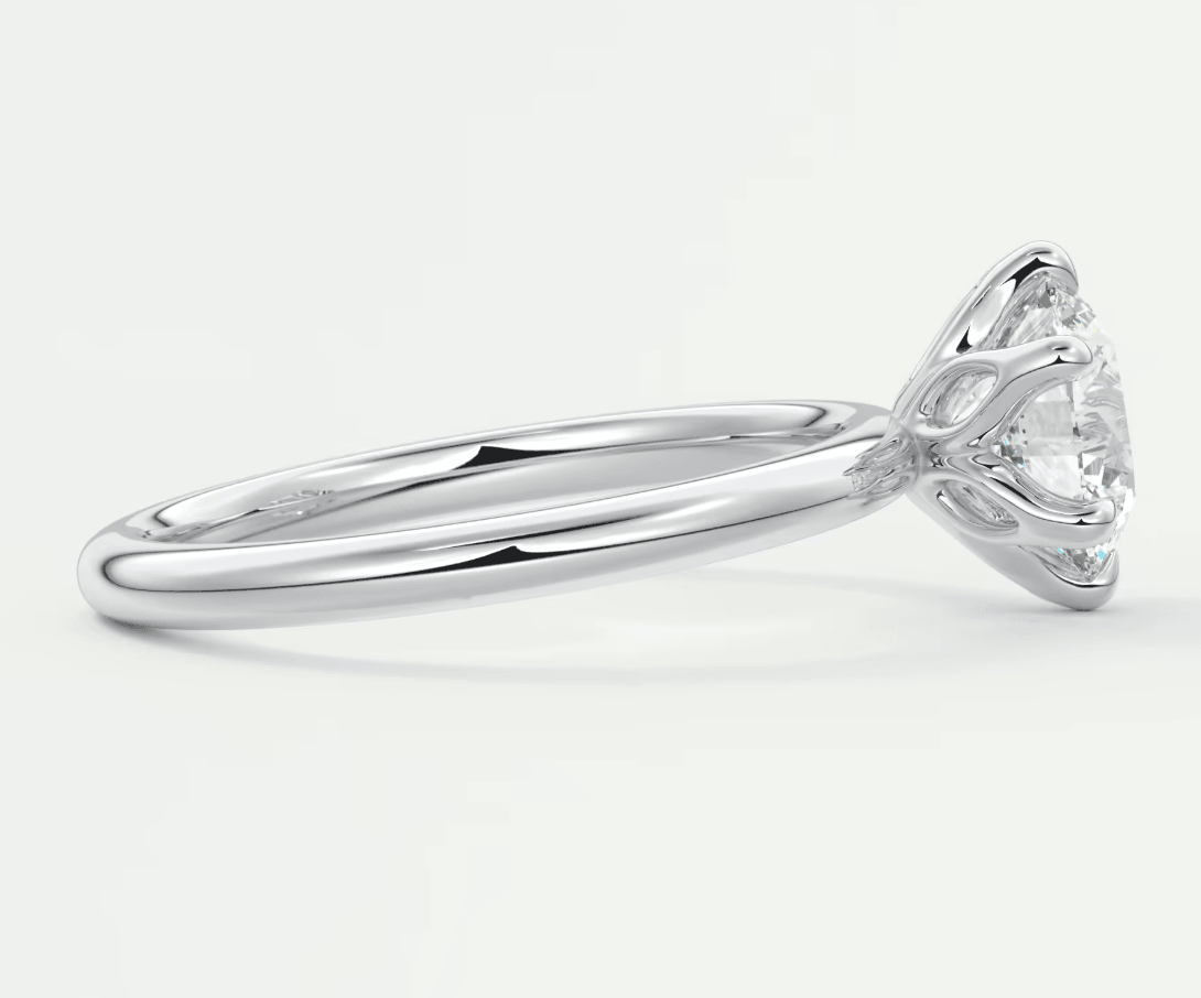 18-karat white gold engagement ring with a round diamond.