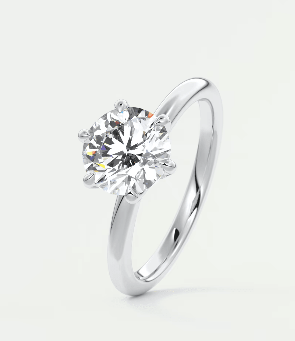 18-karat white gold solitaire diamond engagement ring.