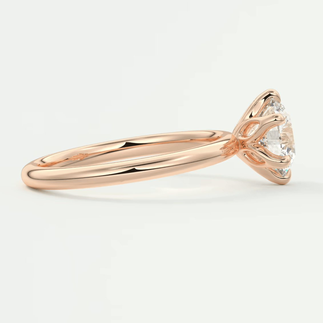 18-karat rose gold engagement ring with a princess-cut diamond.
