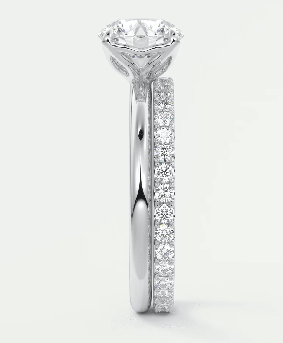 18k white gold diamond engagement ring with a round brilliant cut center stone and pave set diamonds on the band.