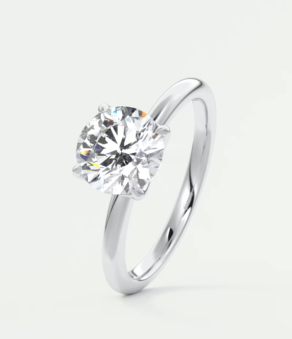 18-karat white gold solitaire diamond engagement ring.