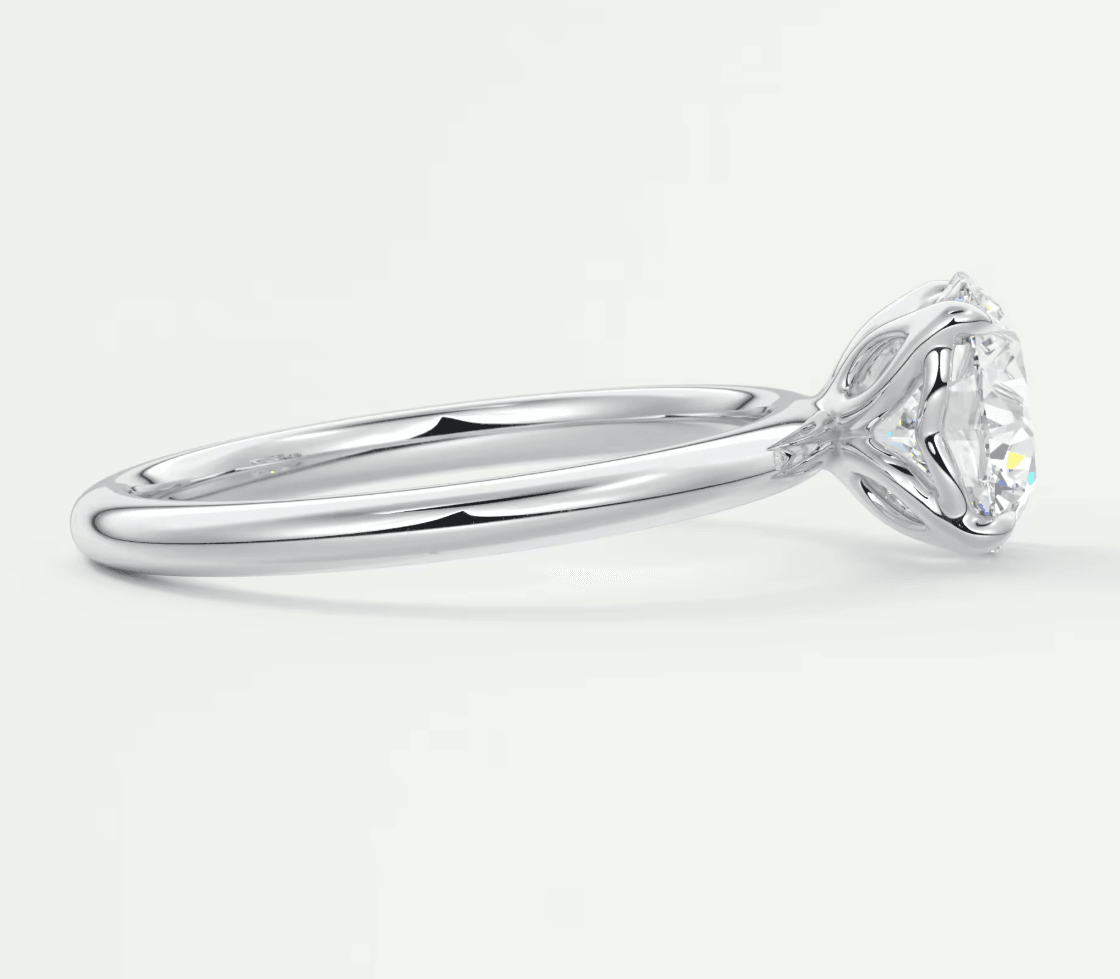 18-karat white gold solitaire engagement ring with a round diamond.