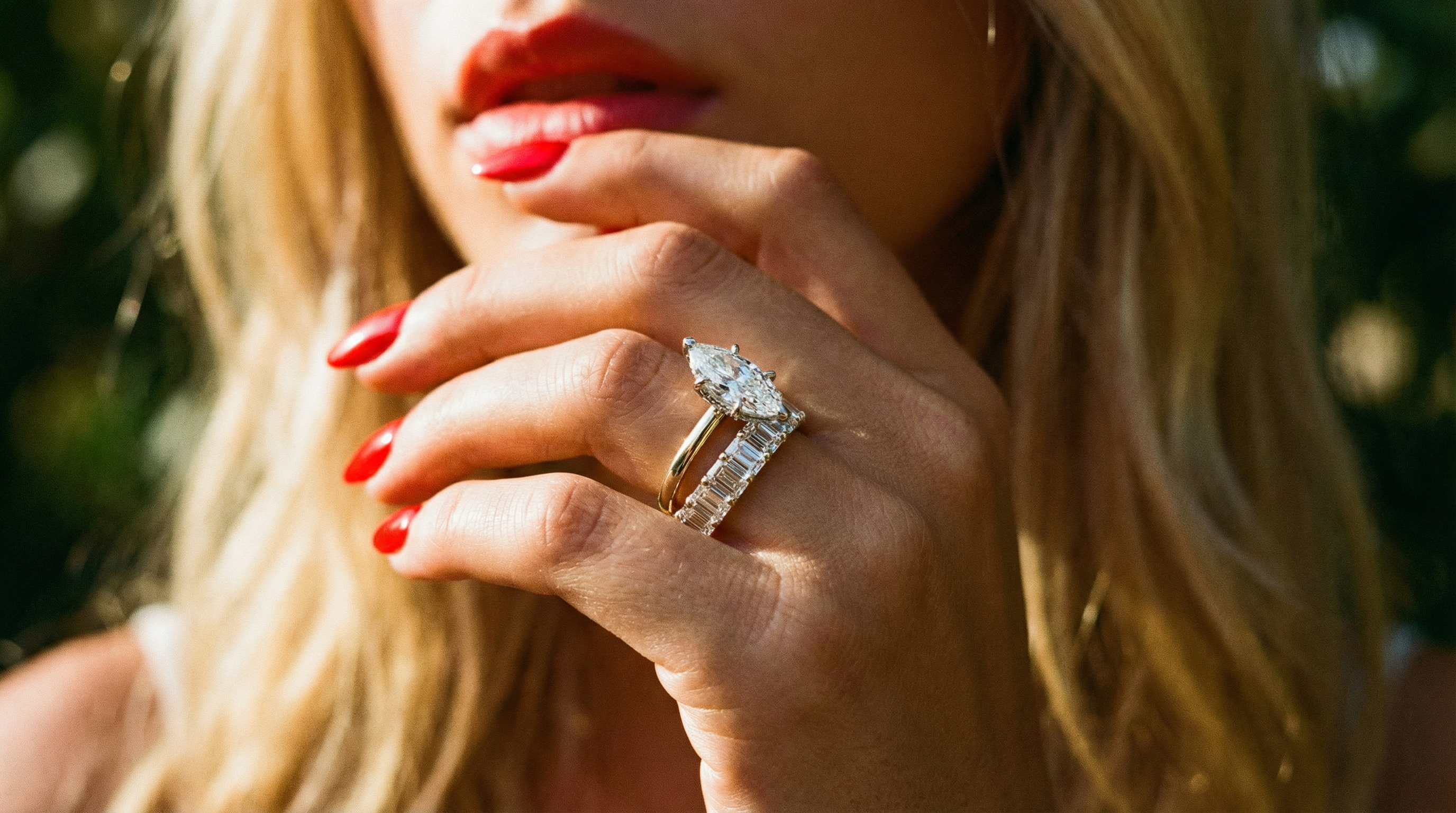 Close-up of a woman's hand wearing a diamond ring with a blurred background