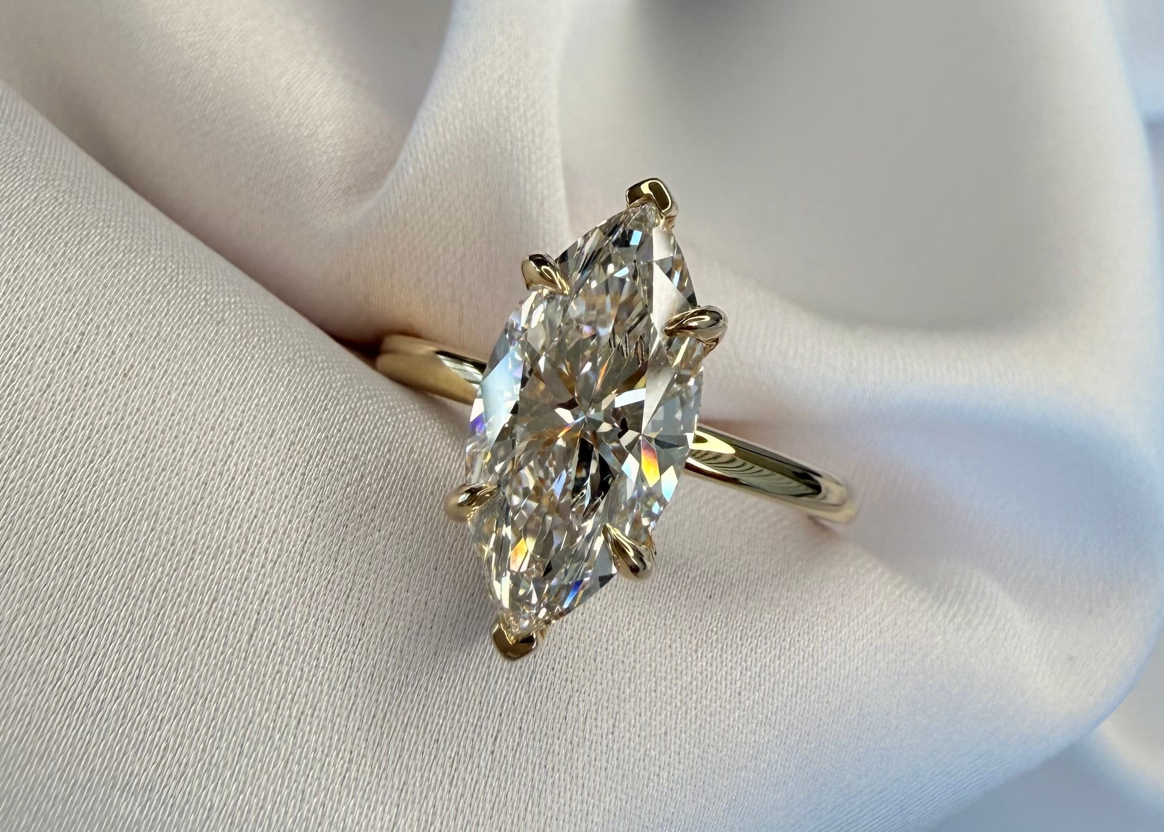 Marquise Diamond ring on a white fabric background