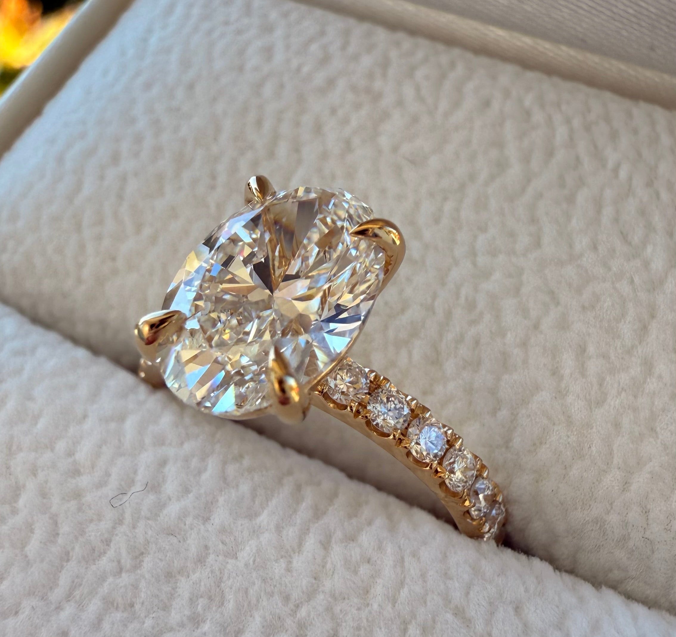 Diamond ring with gold band on a textured surface