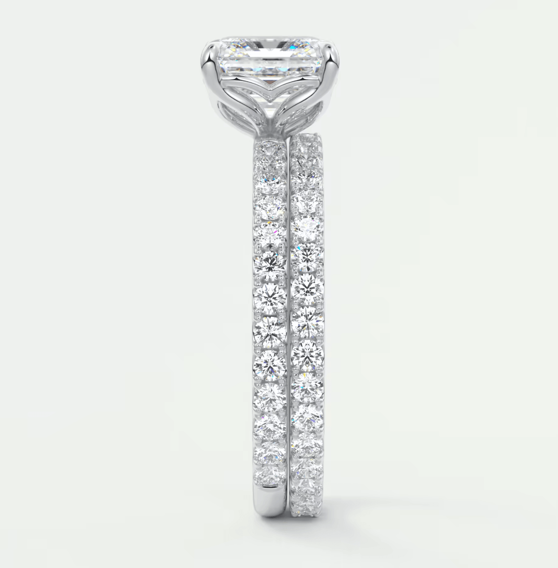18-karat white gold diamond engagement ring with a princess-cut center stone and pave-set diamonds on the band.