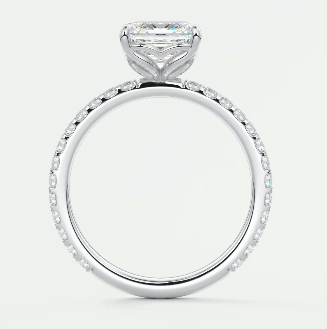 18k white gold engagement ring with a princess cut diamond and pavé set diamonds on the band.