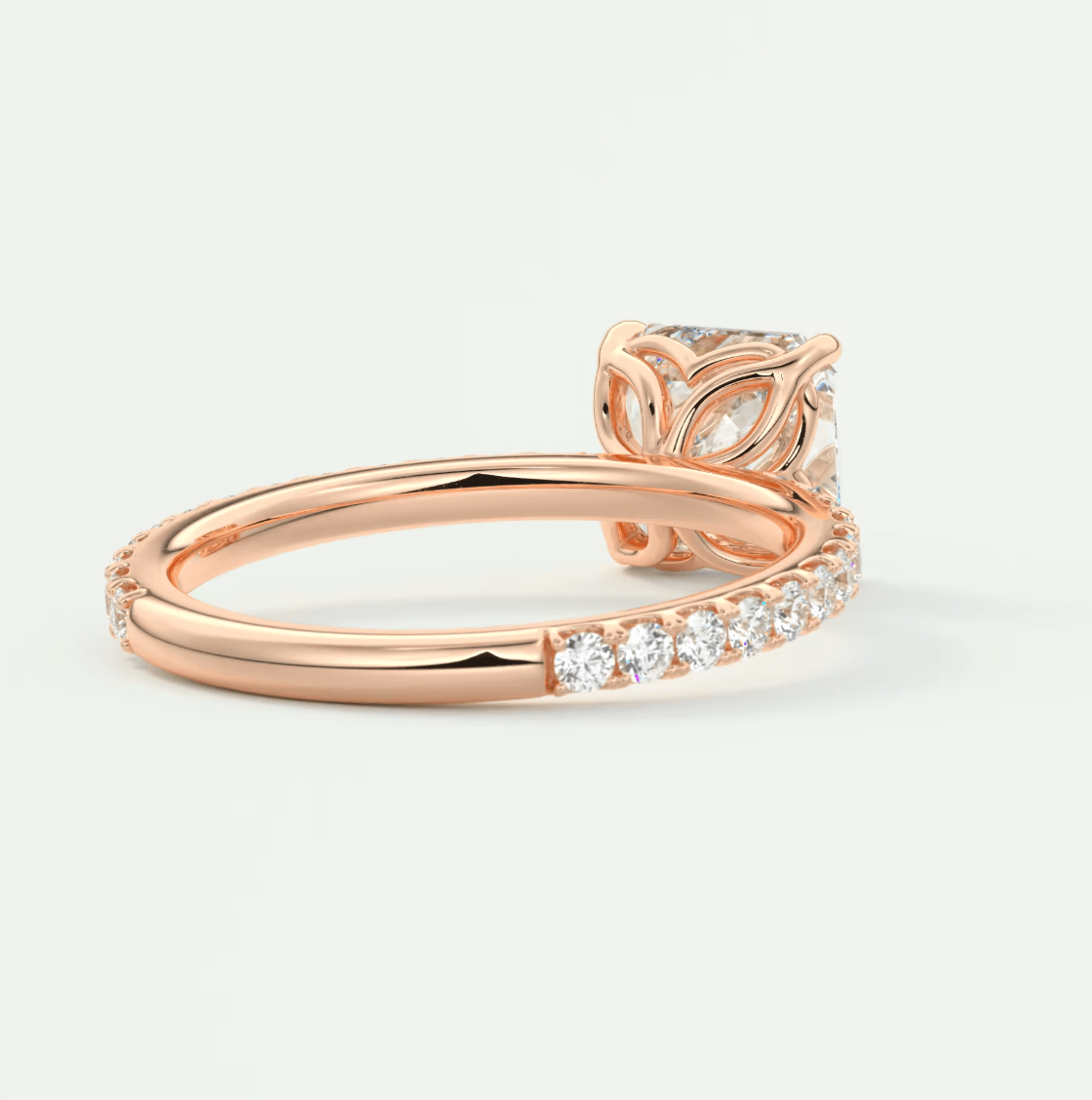 Rose gold diamond engagement ring with leaf design and band of small diamonds