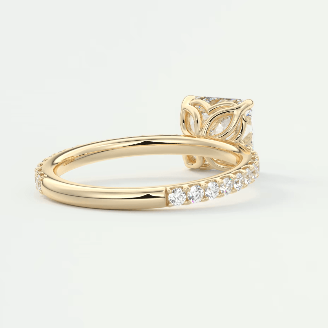 18k yellow gold engagement ring with a princess cut diamond and pavé side stones.