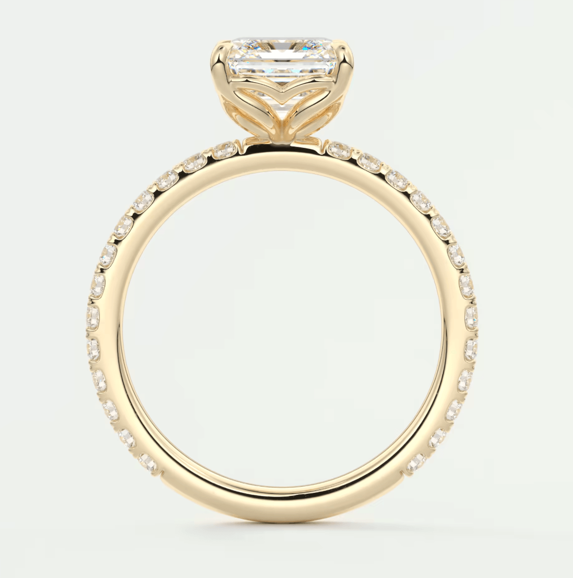 18k yellow gold engagement ring with a princess cut diamond and pavé set diamonds on the band.