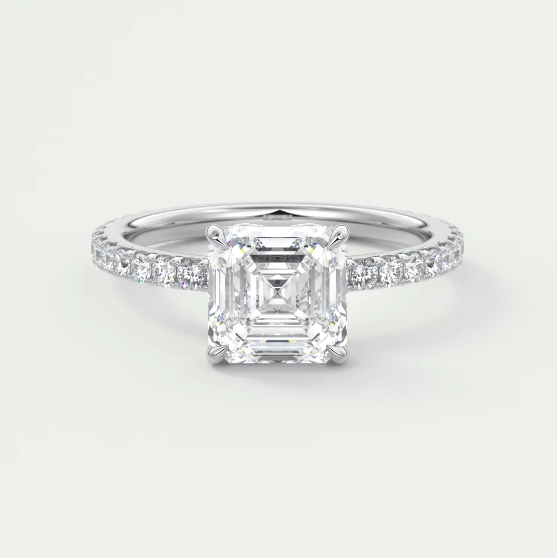 18k white gold emerald cut diamond engagement ring with a pave set band.