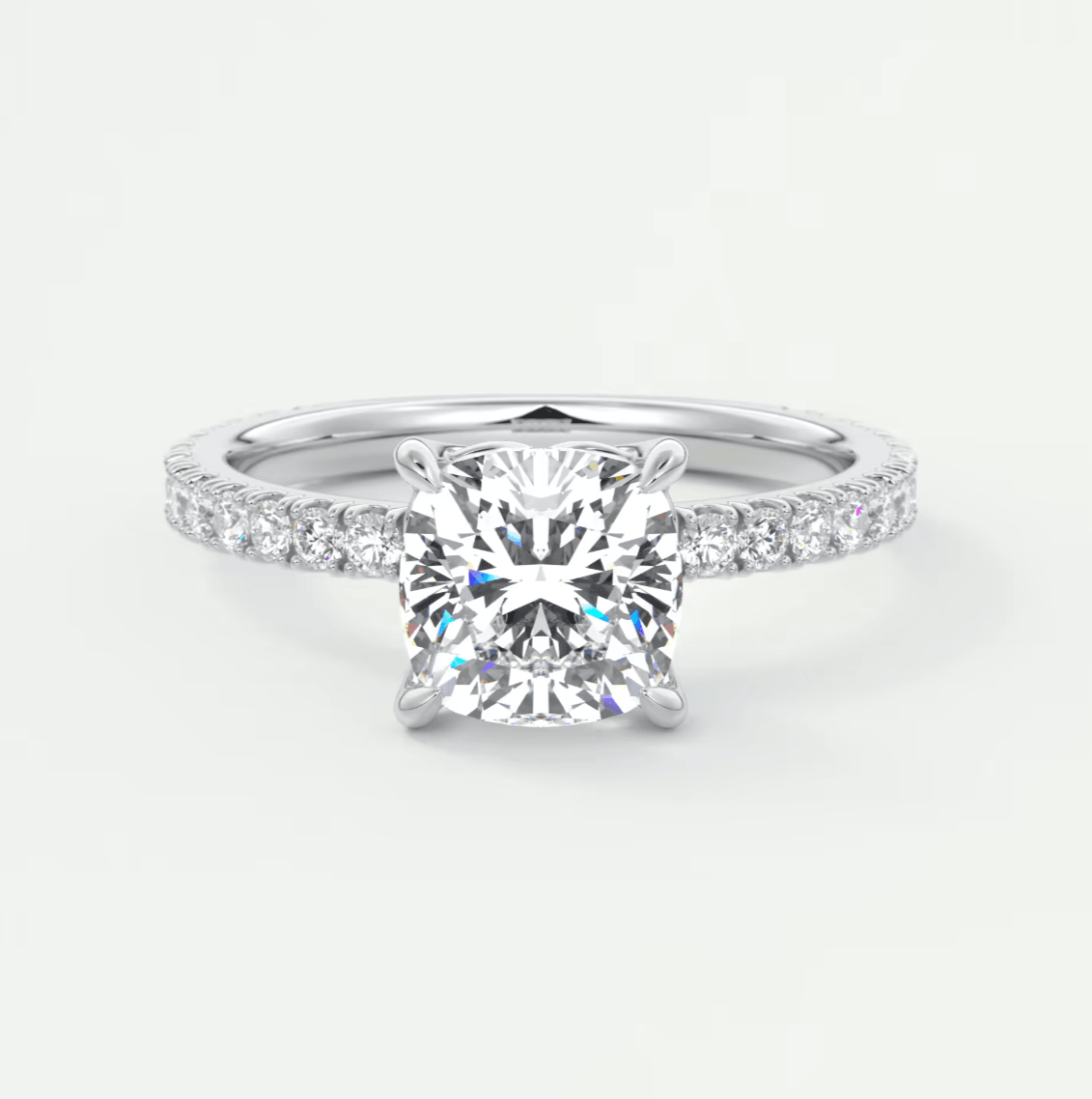Princess cut diamond engagement ring with white gold band and pave set diamonds.