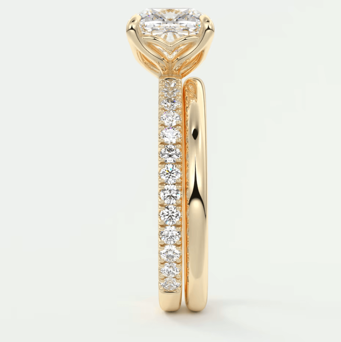 18k yellow gold diamond engagement ring with a heart-shaped center stone and pavé set diamonds on the band.