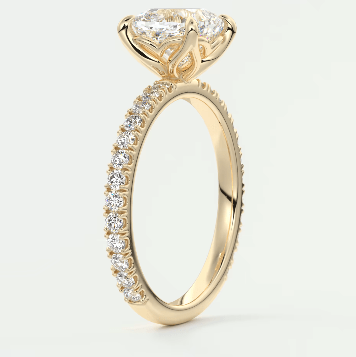 18k yellow gold engagement ring with a princess cut diamond and pavé set diamonds on the band.