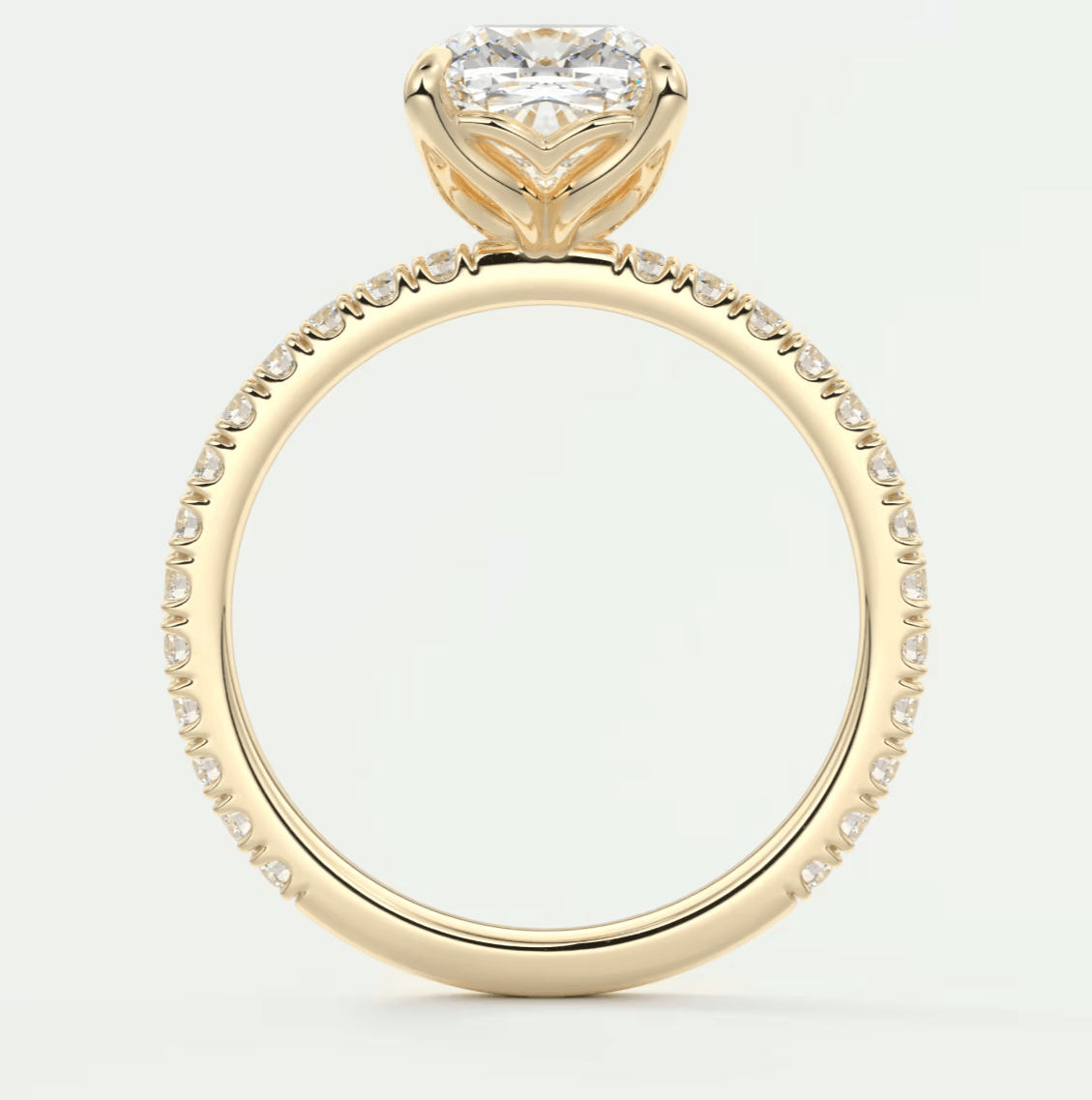 18-karat yellow gold engagement ring with a heart-shaped diamond and pavé set diamonds on the band.