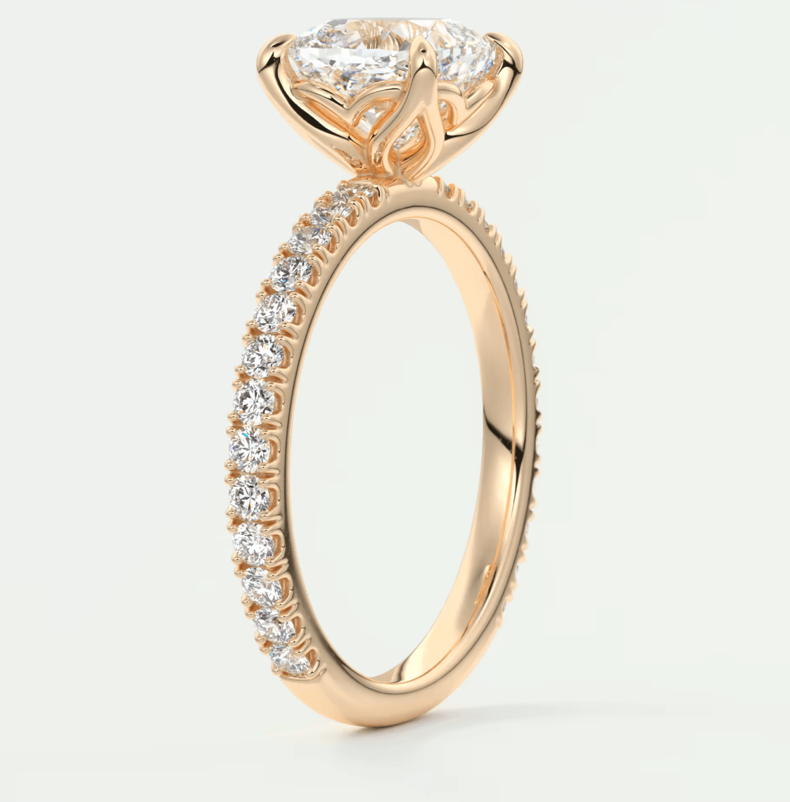 18k rose gold engagement ring with a princess-cut diamond and pavé set diamonds on the band.