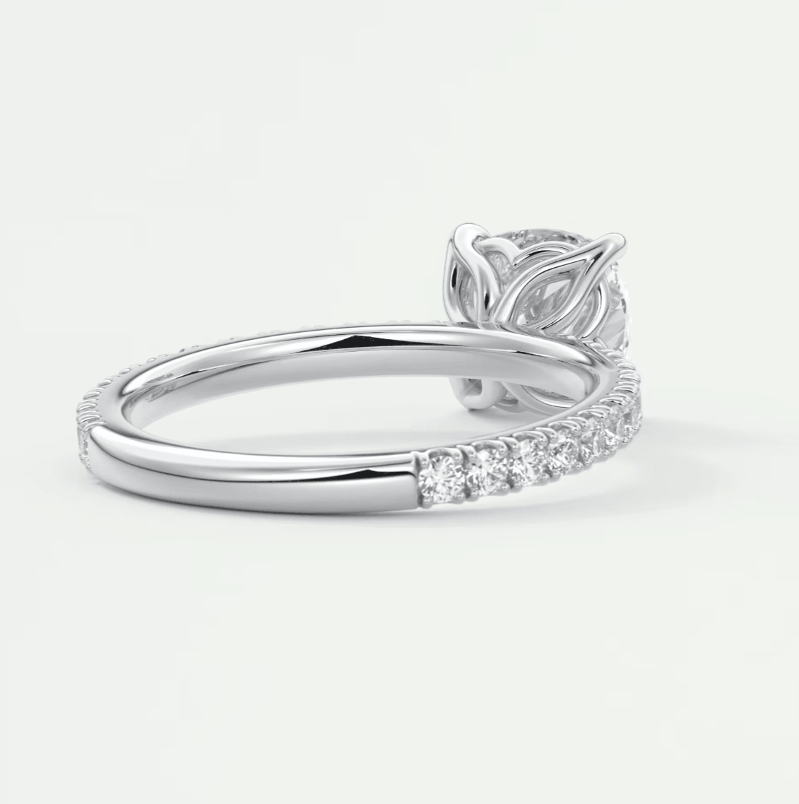 18k white gold diamond engagement ring with a leaf-inspired band and halo design.