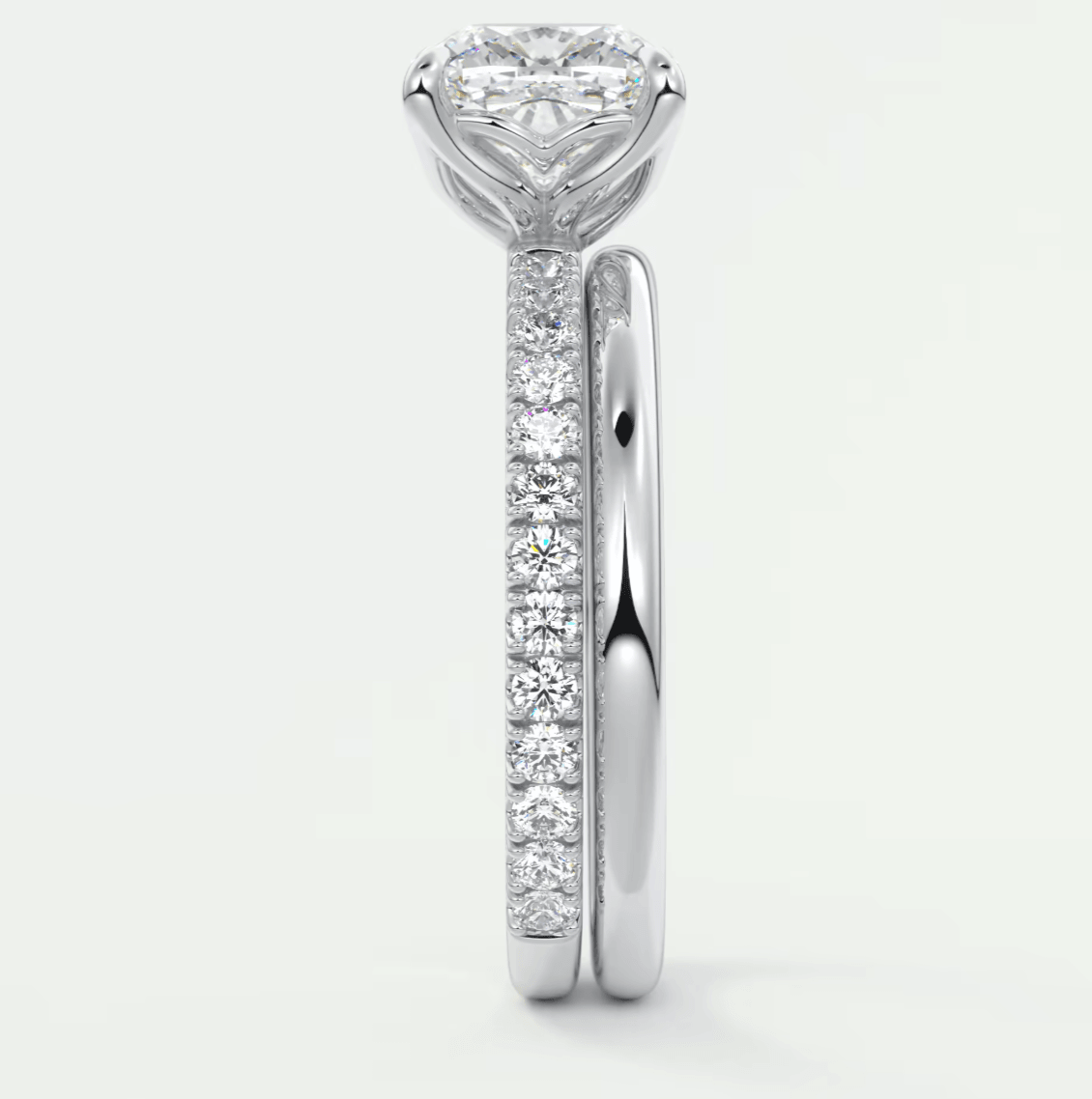 18-karat white gold engagement ring with a princess-cut diamond center stone and pavé set diamonds on the band.