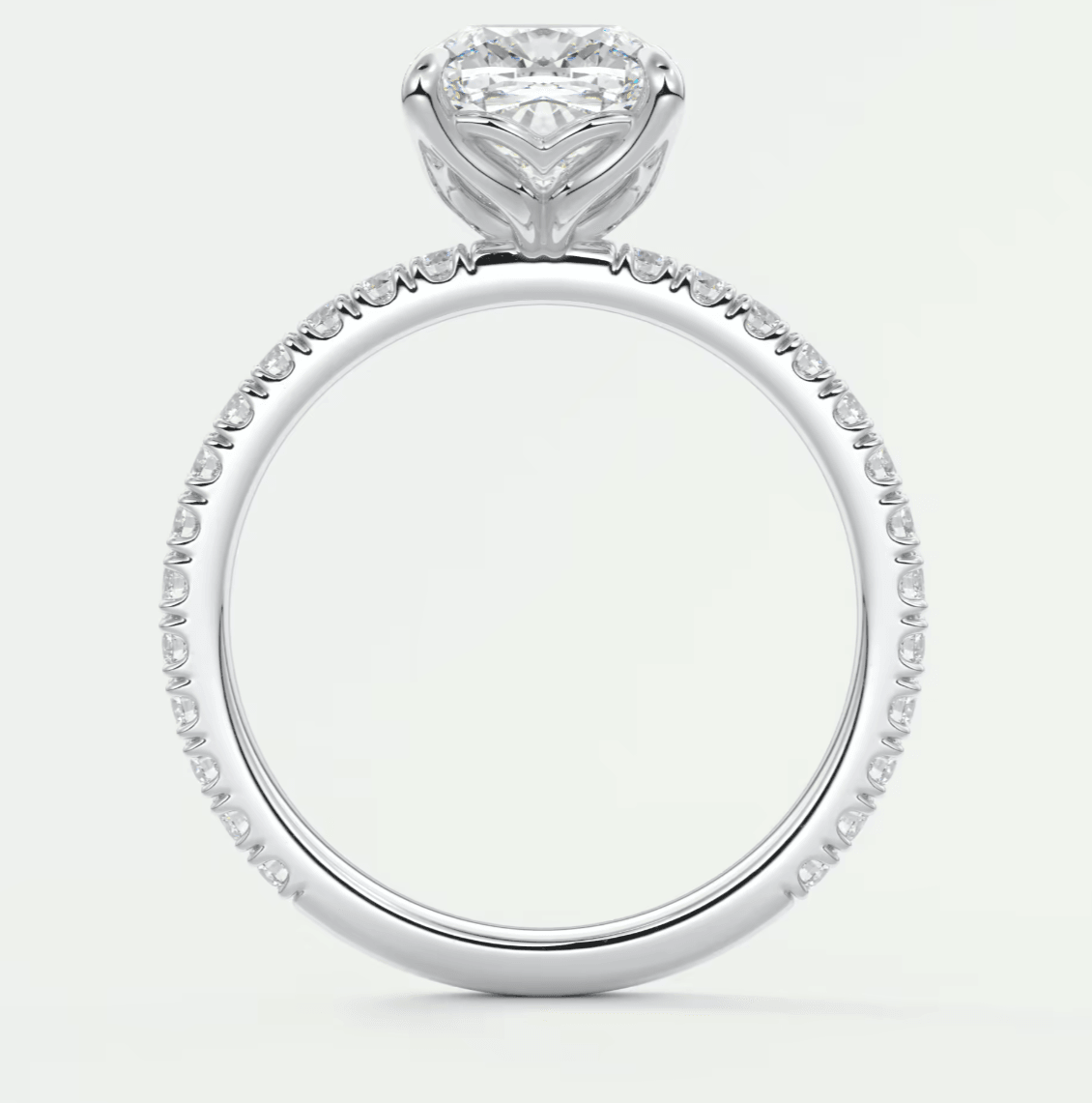 18k white gold heart-shaped diamond engagement ring with a halo of smaller diamonds.