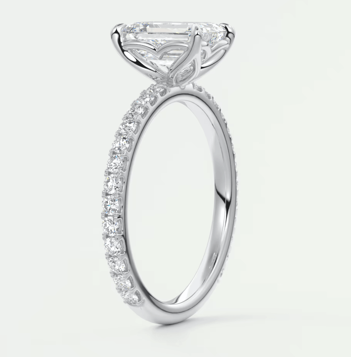 18-karat white gold engagement ring with a princess-cut diamond center stone and pavé set diamonds on the band.