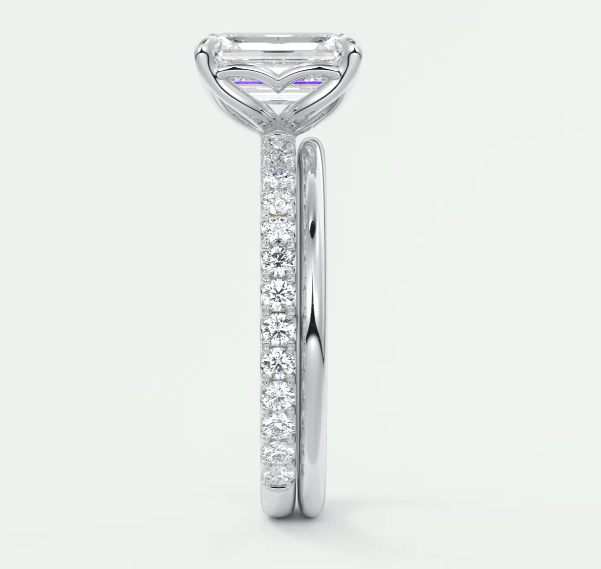 18k white gold engagement ring with a princess cut diamond and pavé set diamonds on the band.