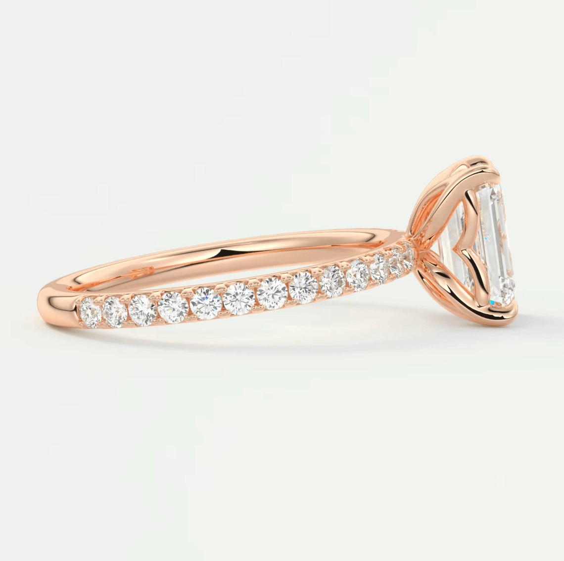 18-karat rose gold engagement ring with a princess-cut diamond and pavé set diamonds on the band.