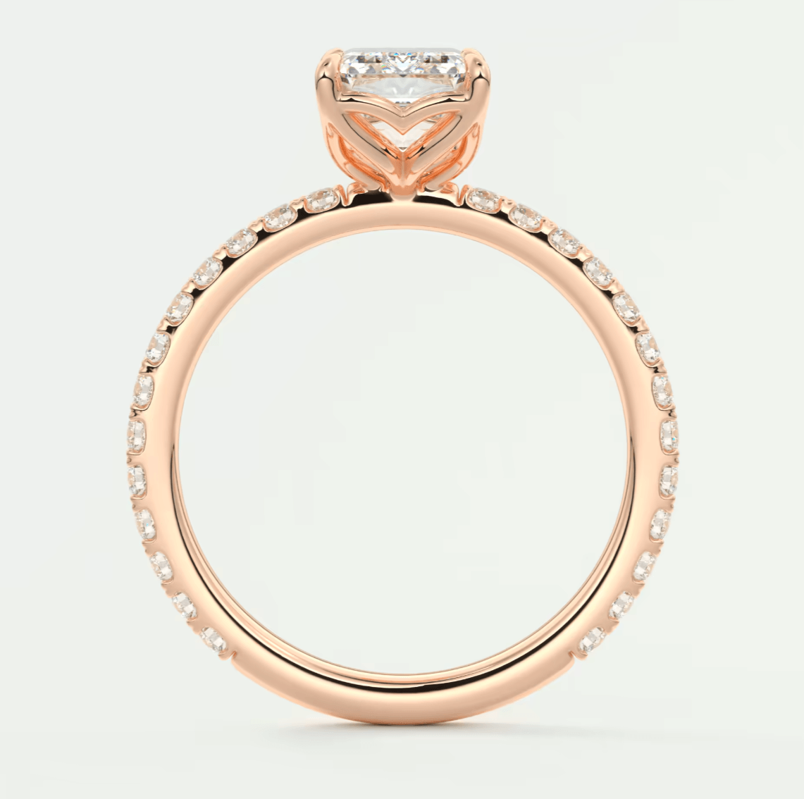 18k rose gold engagement ring with a princess cut diamond and pave set diamonds on the band.