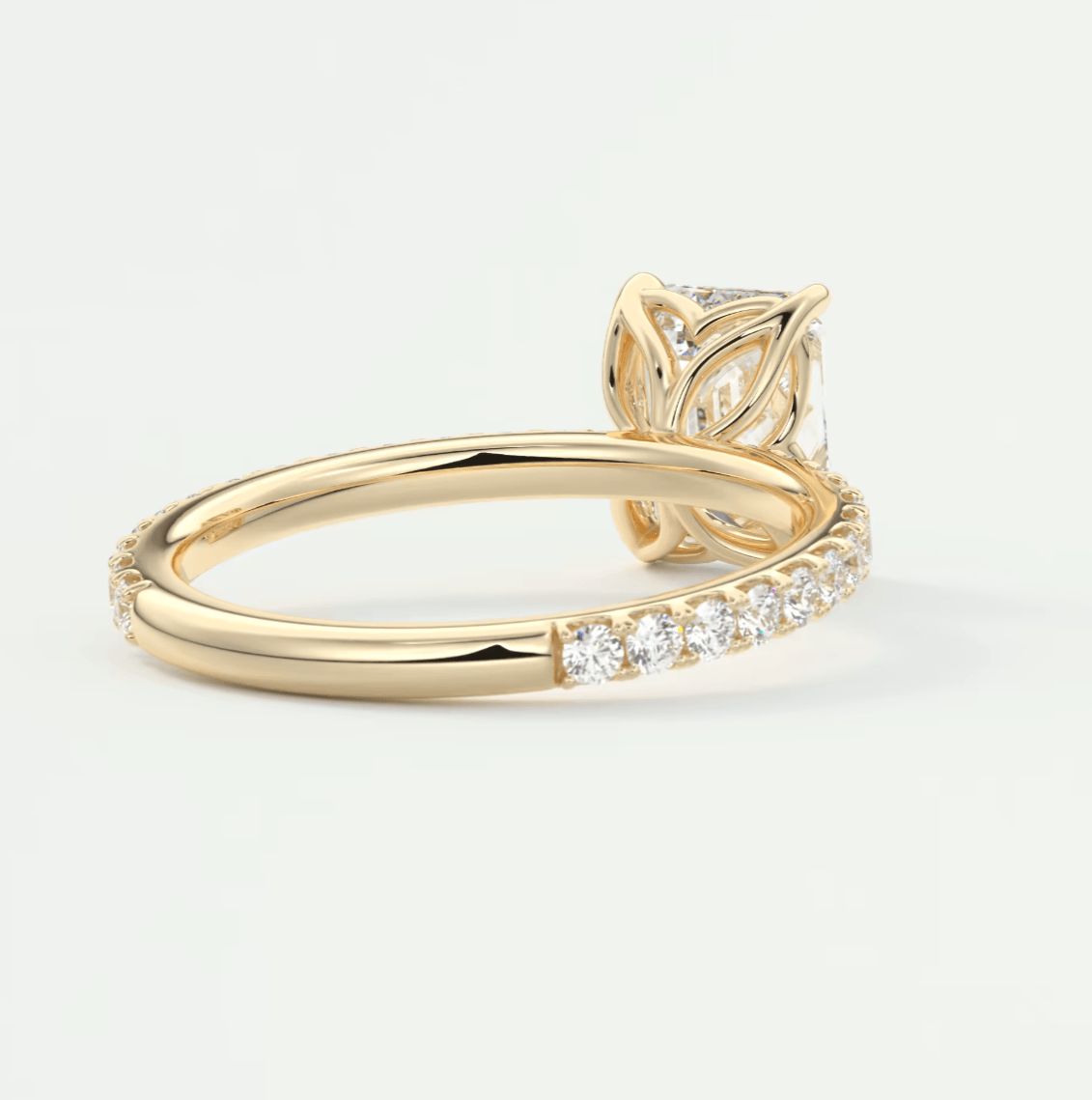 18k yellow gold engagement ring with a leaf-inspired design and pave diamond band.