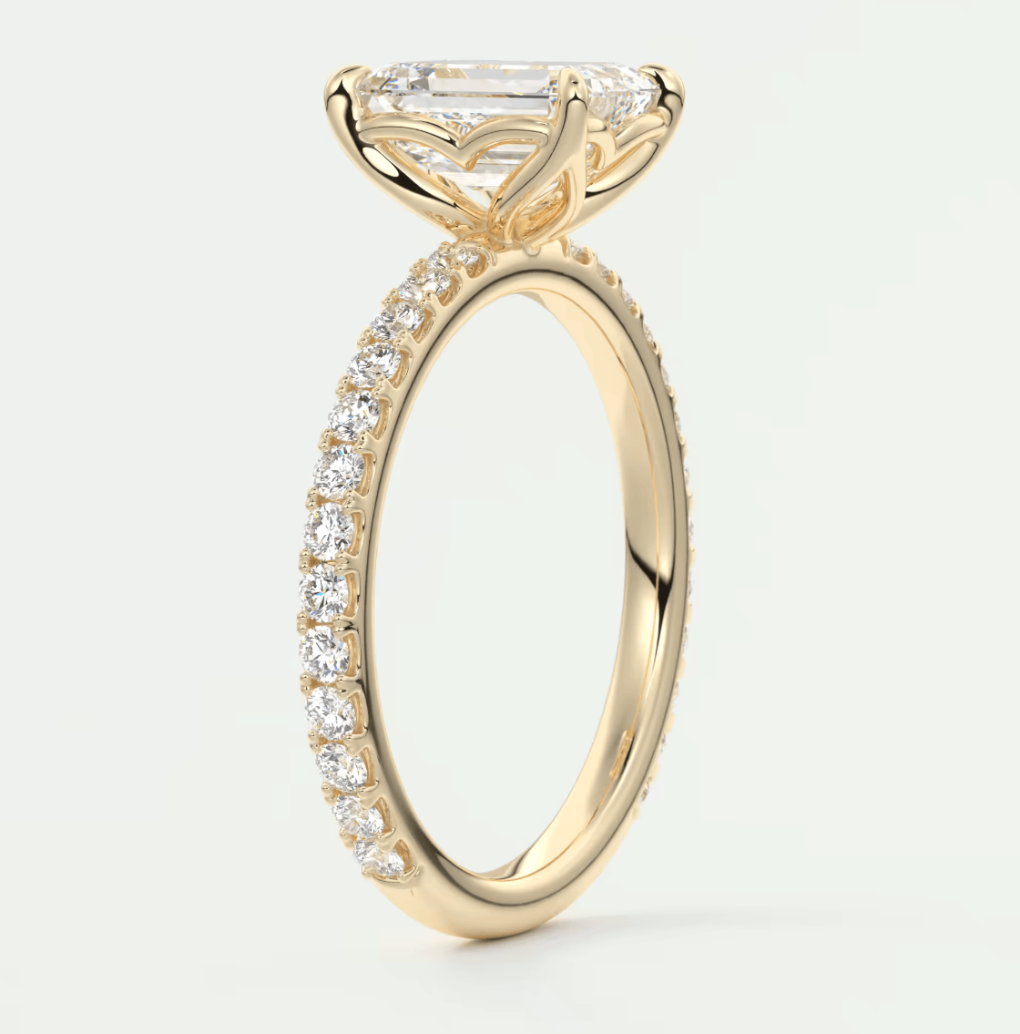 18k yellow gold engagement ring with a princess cut diamond and pavé set diamonds on the band.