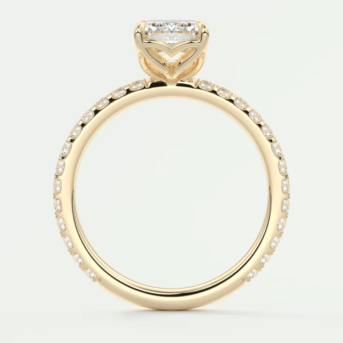 18k yellow gold engagement ring with a princess cut diamond and pavé set diamonds on the band.