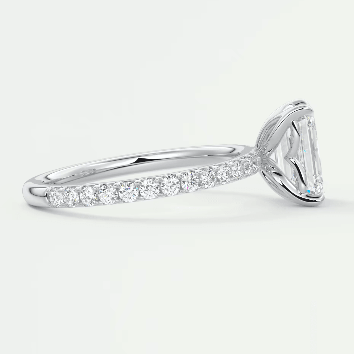 18k white gold diamond engagement ring with a marquise-cut center stone and channel-set side diamonds.