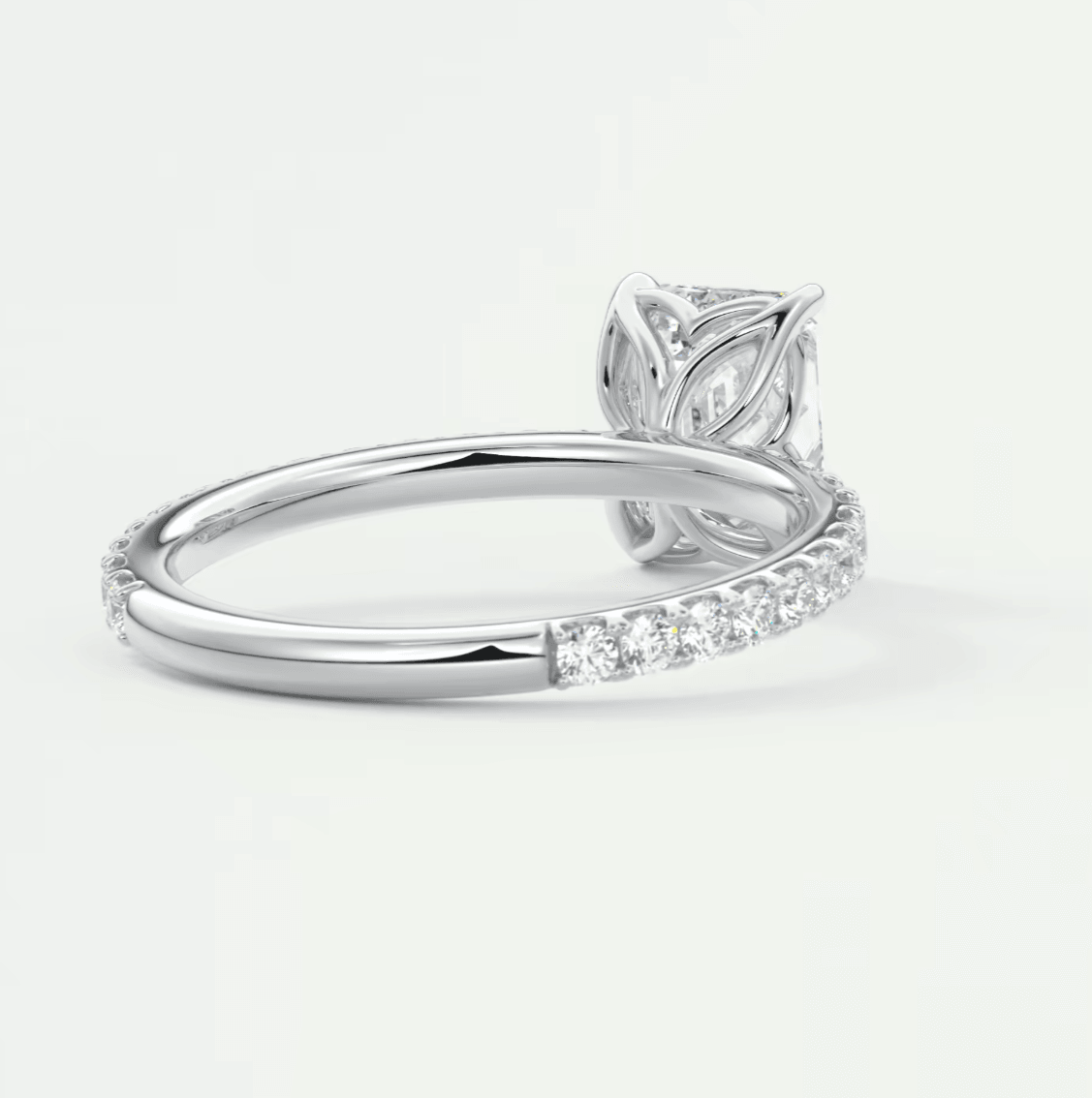 White gold diamond engagement ring with leaf design and band of diamonds.