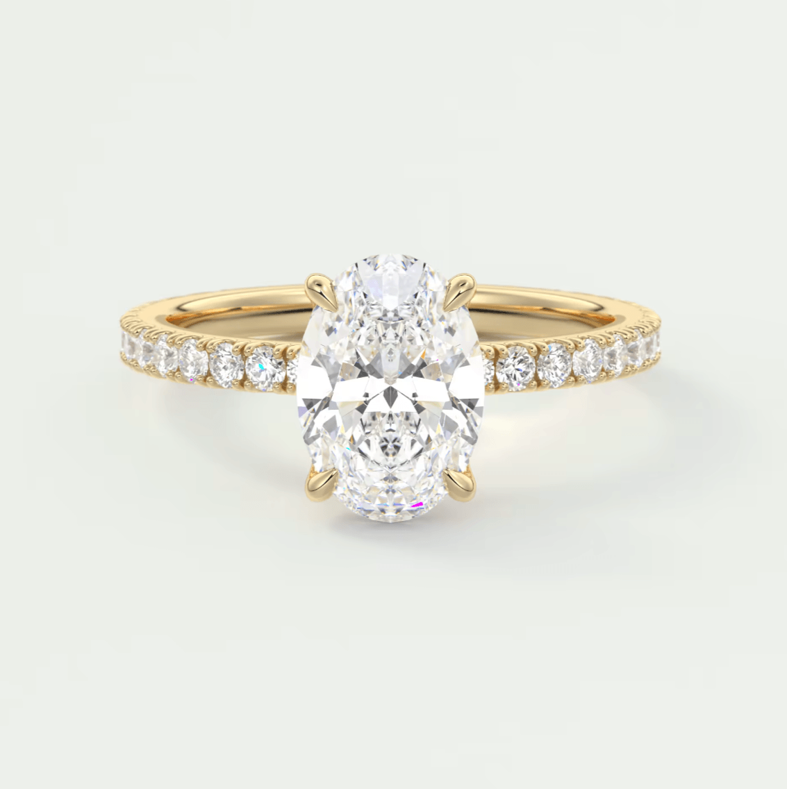 18k yellow gold engagement ring with an oval diamond center stone and channel set diamonds on the band.