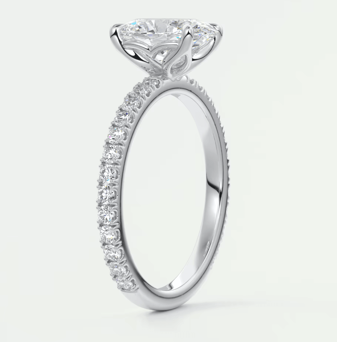 18-karat white gold engagement ring with a princess-cut diamond center stone and pavé set diamonds on the band.