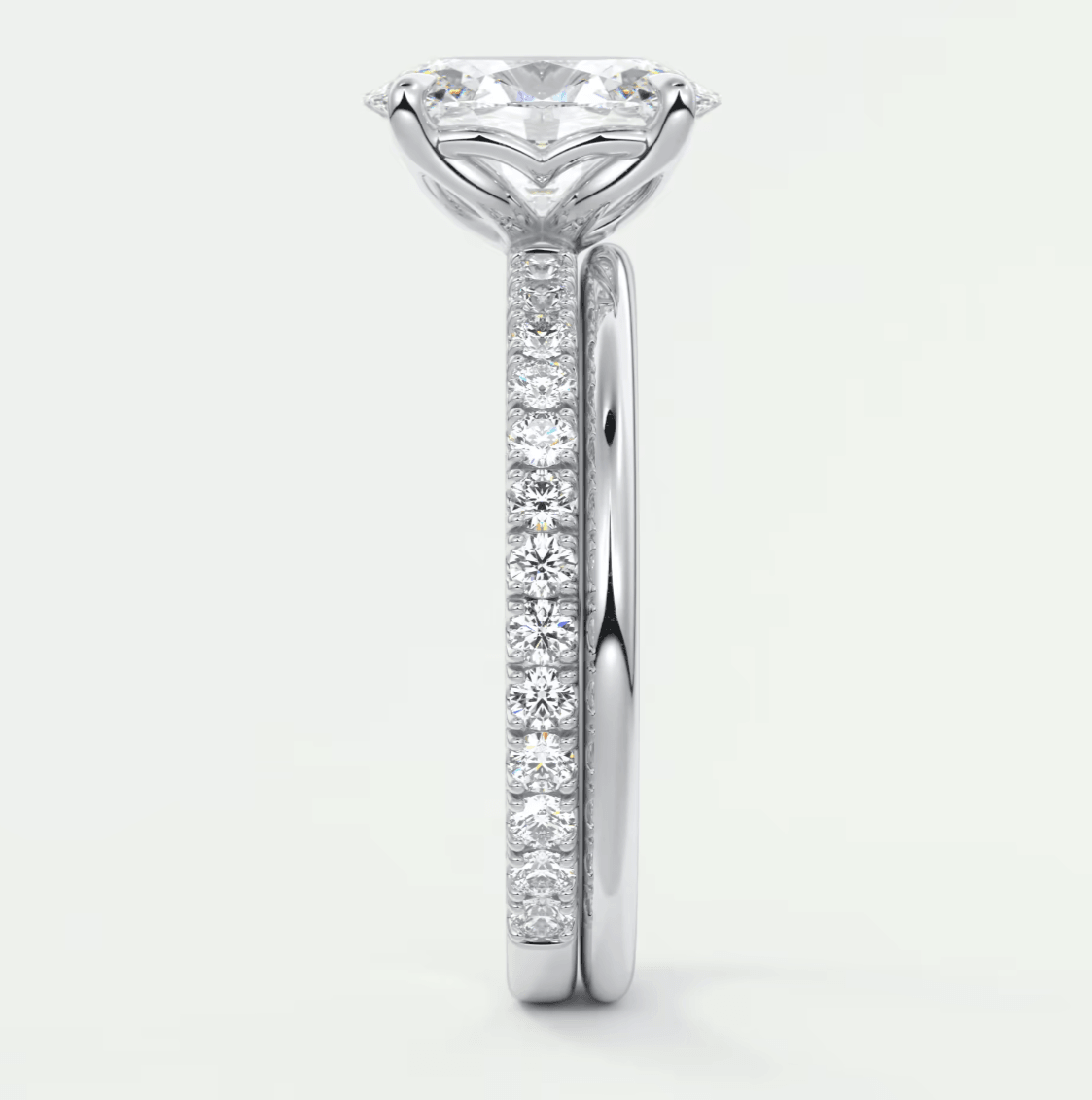 18-karat white gold engagement ring with a large, round diamond center and smaller diamonds set in the band.