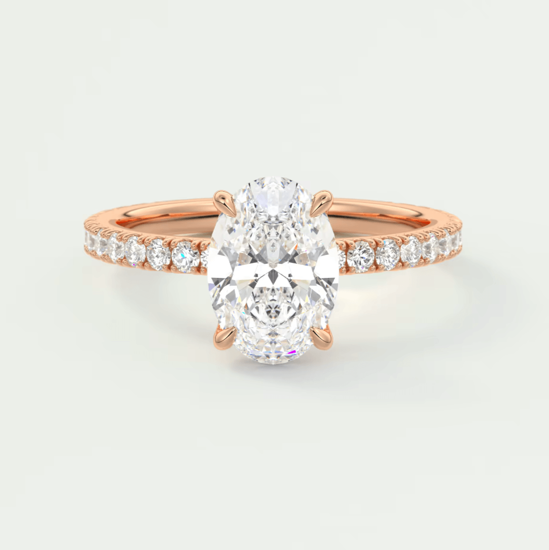Rose gold diamond engagement ring with an oval-cut center stone and channel-set diamonds on the band.